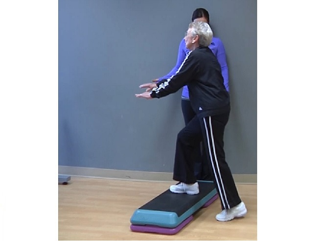 older woman demonstrating step up exercise